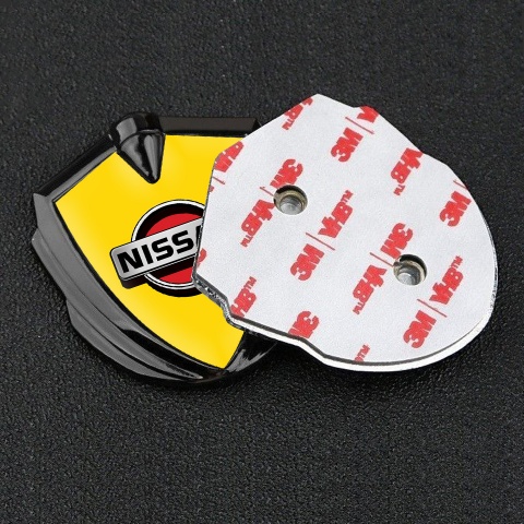 Nissan Badge Self Adhesive Graphite Yellow Background Front Grey Logo
