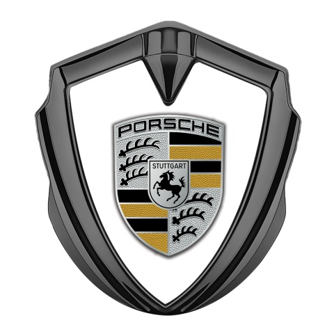 Porsche Abzeichen selbstklebend Graphit Tonfarbe mit Weiss Hintergrund und Gelb Elemente Logo