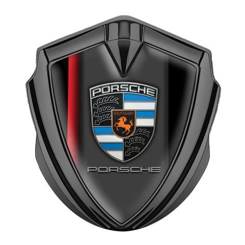 Porsche Abzeichen selbstklebend Graphit Tonfarbe mit Schwarz Rote Elemente Hintergrund
