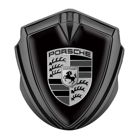Porsche Abzeichen selbstklebend Graphit Tonfarbe mit Schwarz Hintergrund und Grau Schwarz Logo