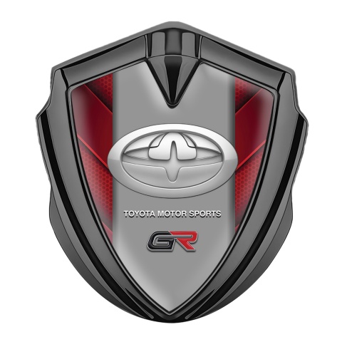 Toyota GR Emblem Abzeichen selbstklebend Graphit Tonfarbe mit Rote Elemente und Neues Design Logo