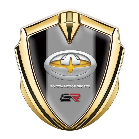 Toyota GR Emblem Auto Zeichen Goldtonfarbe mit Schwarz Hintergrund und Gelb Motiv logo