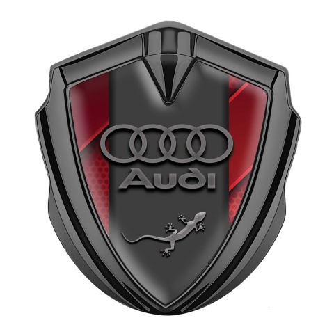 Audi Quattro Emblem Abzeichen Graphit Tonfarbe mit Rote Fragmente Hintergrund und Grau logo