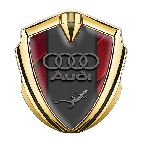 Audi Quattro Emblem Abzeichen Goldtonfarbe mit Rote Fragmente Hintergrund und Grau logo