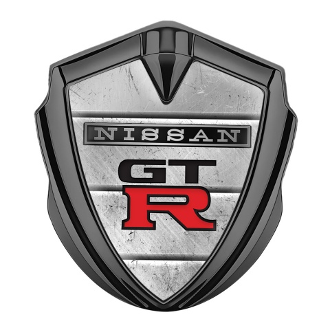 Nissan GTR Emblem Auto Zeichen Graphit Tonfarbe Steinplatten Hintergrund mit Schwarz Rote Logo