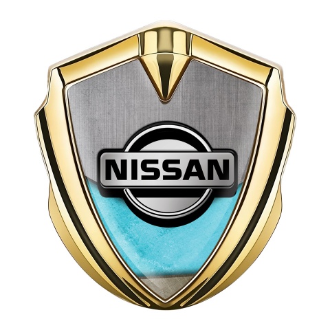 Nissan Emblem Abzeichen selbstklebend Goldtonfarbe Turkis Motiv Basis mit Grau Logo