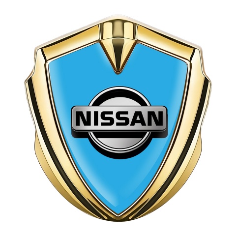 Nissan Emblem Abzeichen selbstklebend Goldtonfarbe Blau Fundament mit Grau logo Stil