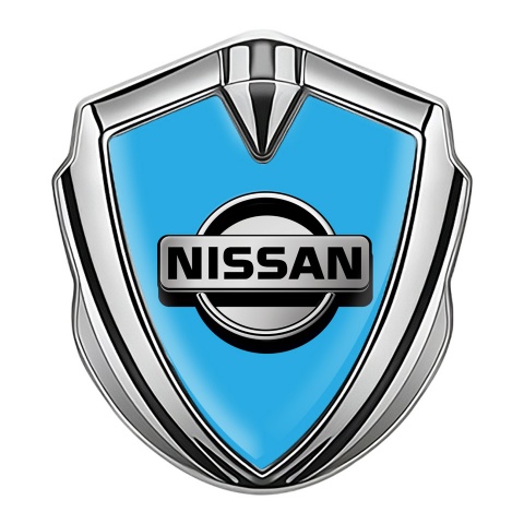 Nissan Emblem Abzeichen selbstklebend Silbertonfarbe Blau Fundament mit Grau logo Stil