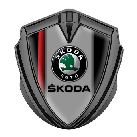 Skoda Emblem Auto Zeichen Graphit Tonfarbe mit Rote Linie auf schwarzem Sockel Design