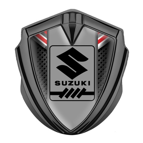 Suzuki Emblem Abzeichen selbstklebend Graphit Tonfarbe Dunkles Gitter mit Rote Fragmente Design