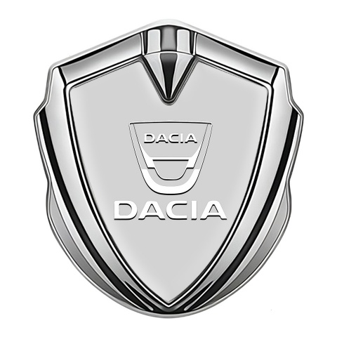 Dacia Abzeichen selbstklebend Silbertonfarbe Grau Basis mit Weiss Logo