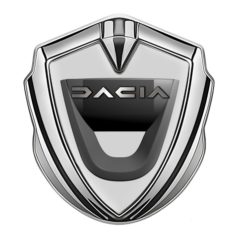Dacia Emblem Auto Zeichen Silbertonfarbe Grau Hintergrund mit Graphit Logo