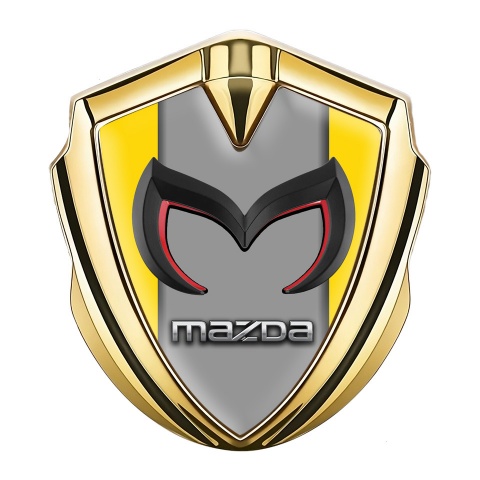 Mazda Emblem Abzeichen selbstklebend Goldtonfarbe mit Gelb Hintergrund und Grau Logo Panel