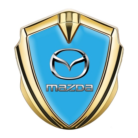 Mazda Abzeichen selbstklebend Goldtonfarbe mit Himmelblau Fundament und Klassisch Logo