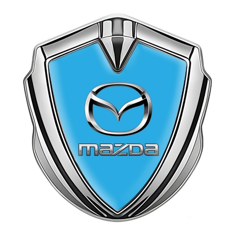 Mazda Abzeichen selbstklebend Silbertonfarbe mit Himmelblau Fundament und Klassisch Logo