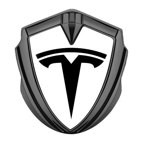 Tesla Emblem Abzeichen Graphit Tonfarbe Weiss Hintergrund mit Grosses Logo Stil