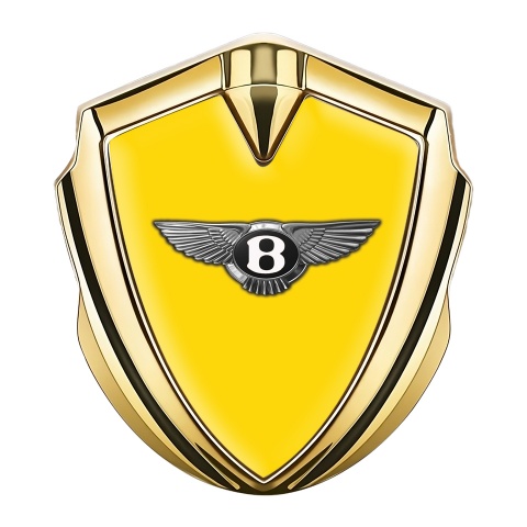 Bentley Emblem Auto Zeichen Goldtonfarbe mit Gelb Hintergrund und Klassisch Logo